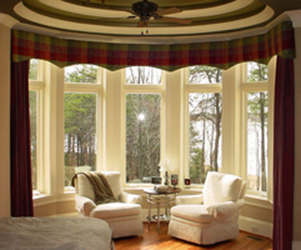 room with bay window, drapes, curtains
